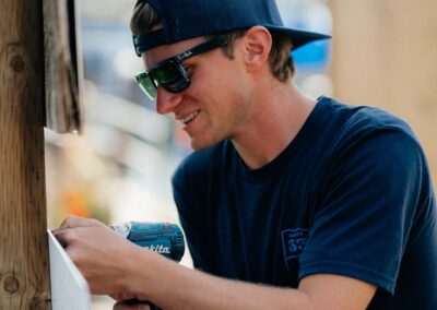 smiling employee using power drill